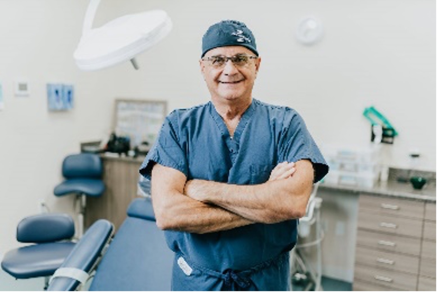 Dr. Pikos, an oral surgeon standing in surgical suite